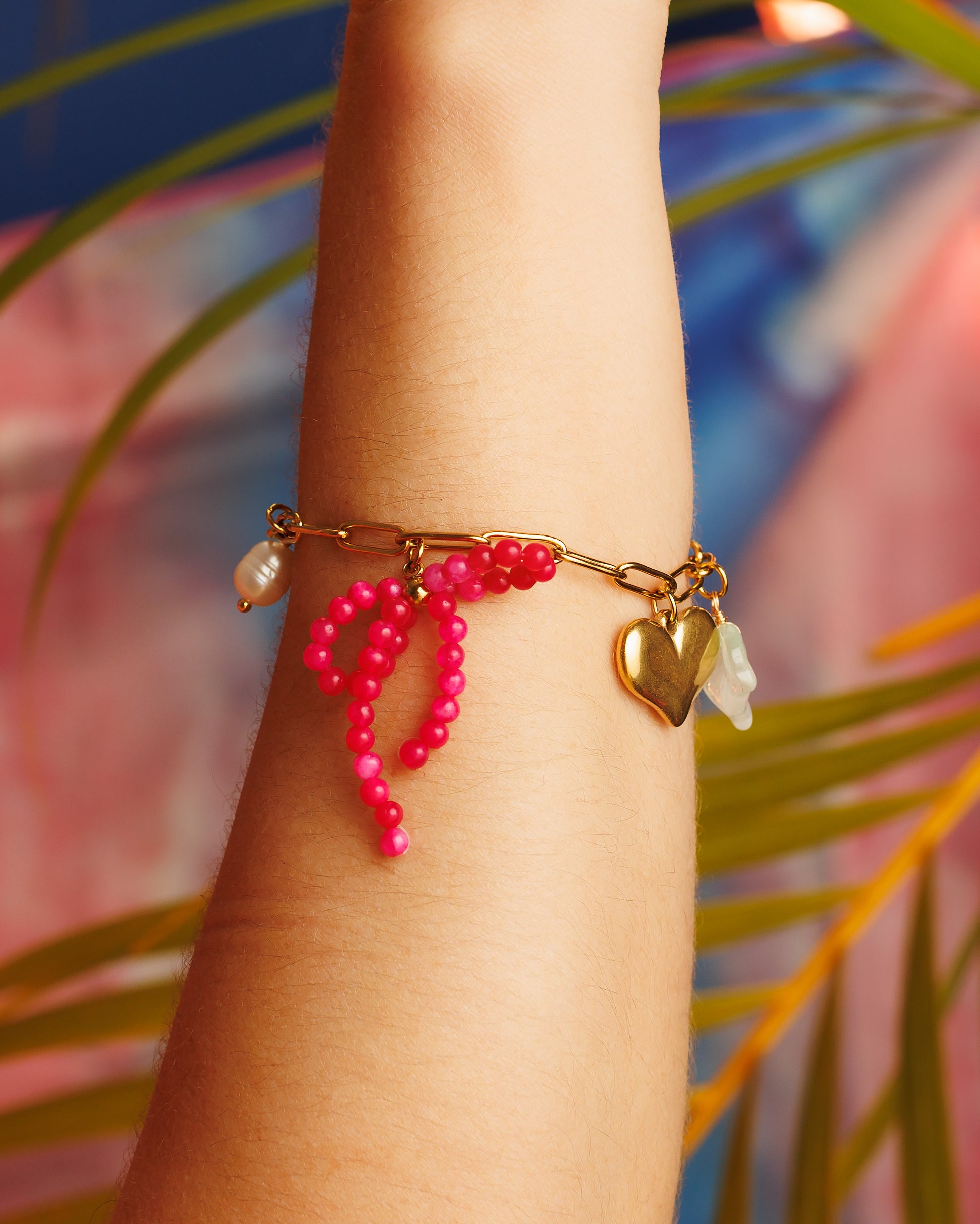 Pulsera de charms con lazo, sol, hoja, perla y corazón